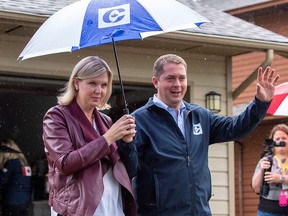 Conservative Party Leader Andrew Scheer and his wife Jill leave a campaign announcement in Surrey, B.C., on Sunday, Sept. 15, 2019.