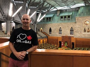 William Lacey is pictured wearing a black shirt with white text that included a heart and Maple Leaf that reads "I love Canadian oil and gas" in a recent handout photo taken inside the House of Commons gallery.