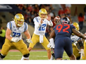 UCLA Bruins quarterback Austin Burton (12) takes the snap during the second half against the Arizona Wildcats at Arizona Stadium on Sept. 28, 2019.