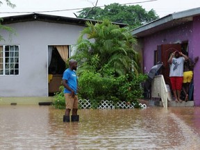 A resident wades through an area flooded by a rain storm caused by Tropical Storm Karen in Barataria, Trinidad and Tobago, on Sept. 22, 2019.