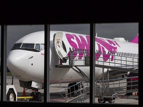 A Swoop Airlines Boeing 737 on display on June 19, 2018 at John C. Munro International Airport in Hamilton, Ont. (THE CANADIAN PRESS/Tara Walton)