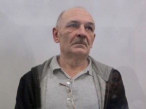Volodymyr Tsemakh, suspected of involvement in the downing of the Malaysia Airlines flight MH17 plane in 2014, stands inside a defendants' cage during a court hearing in Kiev, Ukraine September 5, 2019.