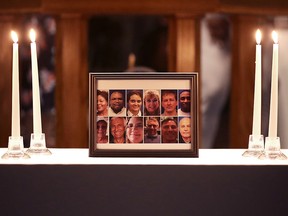 A photograph of the victims of a mass shooting is surrounded by 12 candles during a memorial service at Piney Grove Baptist Church June 2, 2019 in Virginia Beach, Va.