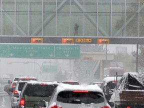 Pedestrians are seen crossing Macleod Trail in a +15 near Chinook Centre while motorists are seen dealing with the white stuff as the city remains under an Environment Canada Heavy Snowfall Warning. Sunday, Sept. 29, 2019.
