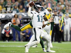 Carson Wentz of the Philadelphia Eagles throws a pass while being pressured by Tramon Williams of the Green Bay Packers in the third quarter at Lambeau Field on Sept. 26, 2019 in Green Bay, Wis.