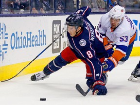 Zach Werenski of the Columbus Blue Jackets and Casey Cizikas of the New York Islanders battle for the puck during a game on October 6, 2017 at Nationwide Arena in Columbus. (Kirk Irwin/Getty Images)