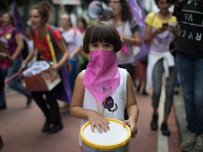 Women wear pink masks protesting violence against women in Rio de Janeiro, Brazil, on November 28, 2017. (LEO CORREA/AFP/Getty Images)