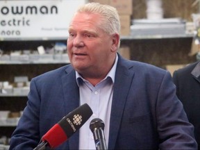 Ontario Premier Doug Ford talking to the press at Bowman Electric in Kenora, Ont., on Oct. 16.