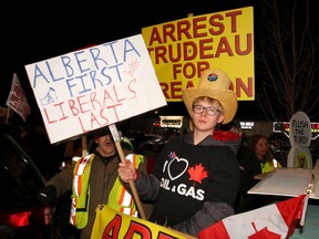 Protesters greet Liberal Leader Justin Trudeau before he took the stage during a rally held late Saturday evening at the Magnolia Banquet Hall during the last days of the federal election campaign on Saturday, Oct. 19.