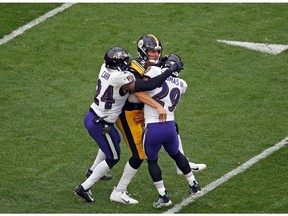 Mason Rudolph #2 of the Pittsburgh Steelers is injured as he is tackled by Earl Thomas #29 and Brandon Carr #24 of the Baltimore Ravens on October 6, 2019 at Heinz Field in Pittsburgh, Pennsylvania.