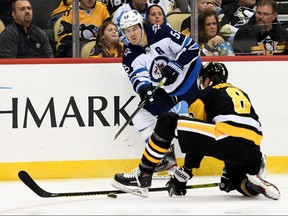 PITTSBURGH, PA - OCTOBER 08: Mark Scheifele #55 of the Winnipeg Jets attempts a pass as Brian Dumoulin #8 of the Pittsburgh Penguins defends in the third period during the game at PPG PAINTS Arena on October 8, 2019 in Pittsburgh, Pennsylvania. (Photo by Justin Berl/Getty Images)