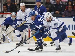 Nikita Kucherov of the Tampa Bay Lightning battles against Kasperi Kapanen of the Toronto Maple Leafs during an NHL game at Scotiabank Arena on October 10, 2019 in Toronto, Ontario, Canada.