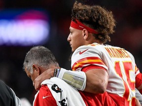 Patrick Mahomes of the Kansas City Chiefs is helped off the field by trainers after sustaining an injury in the second quarter of a game against the Denver Broncos at Empower Field at Mile High on October 17, 2019 in Denver, Colorado.