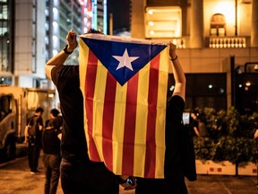 Protesters hold up a Catalan pro-independence Estelada flag during the Hong Kong Catalonia solidarity gathering in Central district on October 24, 2019 in Hong Kong, China.