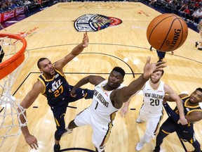 Zion Williamson of the New Orleans Pelicans shoots against Rudy Gobert of the Utah Jazz during the second half of a game at the Smoothie King Center on October 11, 2019 in New Orleans, Louisiana.