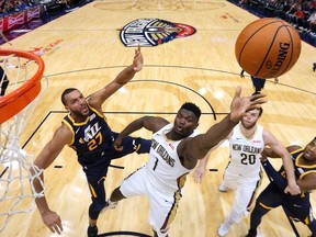 Zion Williamson of the New Orleans Pelicans shoots against Rudy Gobert #27 of the Utah Jazz during the second half of a game at the Smoothie King Center on October 11, 2019 in New Orleans, Louisiana
