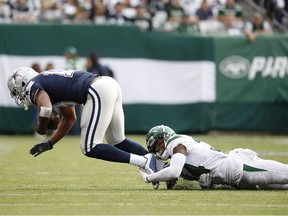 Amari Cooper of the Dallas Cowboys is tackled by Brian Poole of the New York Jets after a completed pass during the first quarter of their game at MetLife Stadium on October 13, 2019 in East Rutherford, New Jersey.