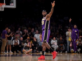 LeBron James of the Los Angeles Lakers celebrates his pass to Anthony Davis for a score during the first half against the Utah Jazz at Staples Center on October 25, 2019 in Los Angeles, California.