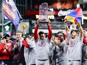 Manager Dave Martinez of the Washington Nationals hoists the Commissioners Trophy after defeating the Houston Astros 6-2 in Game Seven to win the 2019 World Series at Minute Maid Park on October 30, 2019 in Houston, Texas.