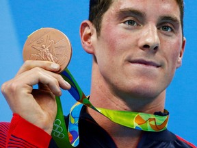 Conor Dwyer of the United States poses with his bronze medal in the men's 200 metre freestyle victory ceremony in Rio de Janeiro, Brazil, August 8, 2016..  (REUTERS/David Gray/File Photo)