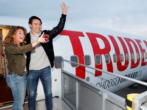 Liberal leader and Prime Minister Justin Trudeau waves with his wife Sophie Gregoire Trudeau as they board the plane at the airport in Vancouver, Oct. 12, 2019. REUTERS/Stephane Mahe