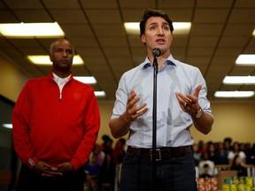 Prime Minister Justin Trudeau speaks next to Liberal candidate for York South-Weston, Ahmed Hussen, during  a Thanksgiving food drive in Toronto, Oct. 13, 2019. REUTERS/Stephane Mahe