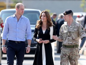 Prince William and Catherine, Duchess of Cambridge walk with British Army Lieutenant Colonel Colin Whitworth as they visit an Army Canine Centre, where Britain provides support to a programme that trains dogs to identify explosive devices, in Islamabad, Pakistan Oct. 18, 2019. (Chris Jackson/Pool via REUTERS)