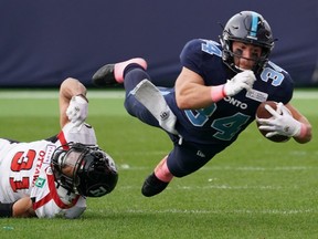 Argonauts' A.J. Ouellette is tackled by Ottawa Redblacks' Kevin Brown during second quarter in CFL action in Toronto on Saturday, Oct. 26, 2019.
