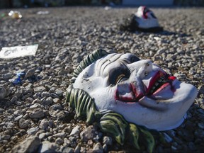 Halloween masks litter the ground amongst signs of chaos at the scene where a mass shooting occurred the night before at Party Venue on Highway 380 in Greenville, Texas, on Sunday, Oct. 27, 2019.  (Ryan Michalesko/The Dallas Morning News via AP)