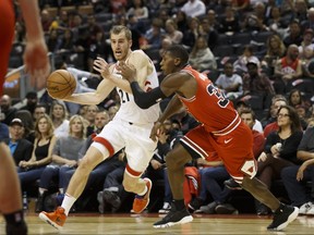 Toronto Raptors guard Matt Thomas drives to the net against Chicago Bulls guard Kris Dunn on Saturday, Oct. 26, 2019.