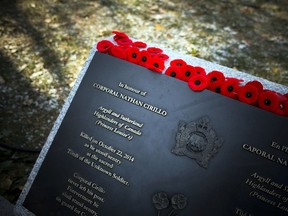 Poppies lay on the monument for Corporal Nathan Cirillo after the National Remembrance Day Ceremony at the National War Memorial in Ottawa on Saturday, November 11, 2017. Ashley Fraser/Postmedia