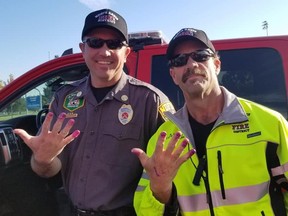 North Davis Fire District Chief Allen Hadley and Capt. Kevin Lloyd with their purple nail polish.