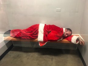 A burglary suspect dressed as Santa Claus sleeps in a jail cell. (Brea Police Department)