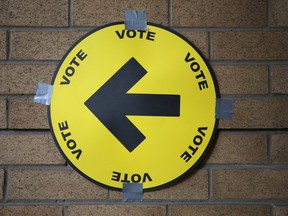 A sign directs voters to a polling station for the federal election in Toronto, Ontario, Canada October 21, 2019.