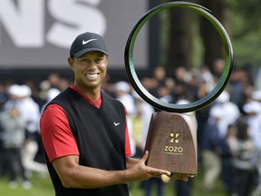 Tiger Woods holds a winning trophy as he celebrates to win the Zozo Championship, a PGA Tour event, at Narashino Country Club in Inzai, Chiba Prefecture, east of Tokyo, Japan October 28, 2019. Kyodo/via REUTERS