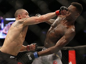 Robert Whittaker (left) and Israel Adesanya fight during UFC 243 at Marvel Stadium on October 6, 2019 in Melbourne, Australia. (Darrian Traynor/Getty Images)