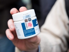 A customer shows a marijuana product that he bought after entering a cannabis store on October 17, 2018 in Montreal, Quebec.