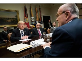 In this file photo taken on January 31, 2017 US President Donald Trump (L), Secretary of Homeland Security John Kelly (2L), Reed Cordish (2R), Director of Government Initiatives, and others listen while former New York Mayor Rudy Giuliani (R) speaks during a meeting on cyber security in the Roosevelt Room of the White House in Washington, DC.