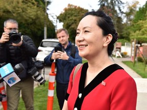 Huawei Chief Financial Officer, Meng Wanzhou, stops to talk to media while leaving her Vancouver home to appear in British Columbia Supreme Court, in Vancouver, on October 1, 2019.
