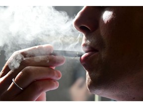 In this file photo taken on Oct. 2, 2018 shows a man exhaling smoke from an electronic cigarette in Washington, DC.