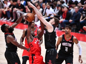 Raptors’ OG Anunoby is blocked by Rockets’ James Harden (left) and Isaiah Hartenstein on Tuesday. Anounby has looked good in camp according to coach Nick Nurse.  Getty Images