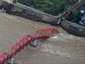 This aerial view shows a damaged train bridge over the swollen Chikuma river in the aftermath of Typhoon Hagibis in Ueda, Nagano prefecture on Oct. 13, 2019. (STR/JIJI PRESS/AFP via Getty Images)
