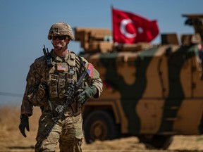 In this file photo taken on Sept. 8, 2019 a U.S. soldier stands guard during a joint patrol with Turkish troops in the Syrian village of al-Hashisha on the outskirts of Tal Abyad town along the border with Turkey. (DELIL SOULEIMAN/AFP via Getty Images)