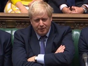 A video grab from footage broadcast by the UK Parliament's Parliamentary Recording Unit (PRU) shows Britain's Prime Minister Boris Johnson reacts as Britain's main opposition Labour Party leader Jeremy Corbyn speaks on a point of order after the House of Commons in London on October 19, 2019.