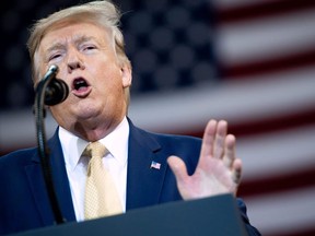 In this file photo taken on October 11, 2019 US President Donald Trump gestures as he speaks during a "Keep America Great" rally at Sudduth Coliseum at the Lake Charles Civic Center in Lake Charles, Louisiana.