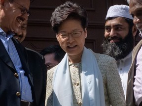 Hong Kong's Chief Executive Carrie Lam, centre, exits the Kowloon Mosque, or Kowloon Masjid and Islamic Centre, in the Tsim Sha Tsui district in Hong Kong on Oct. 21, 2019. (ED JONES/AFP via Getty Images)