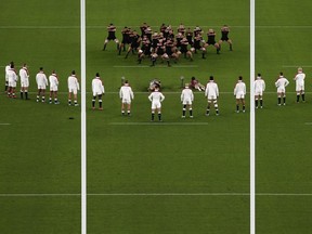 England players stand in a V-formation as New Zealand's players perform the haka before the Japan 2019 Rugby World Cup semi-final match between England and New Zealand at the International Stadium Yokohama in Yokohama on October 26, 2019. (Photo by Behrouz MEHRI / AFP)