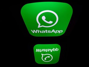 In this file photo taken on December 28, 2016 a picture taken in Paris shows the logo of WhatsApp mobile messaging service. - WhatsApp on Tuesday sued Israeli technology firm NSO Group, accusing it using the Facebook-owned messaging service to conduct cyberespionage on journalists, human rights activists and other. The suit filed in a California federal court contended that NSO Group tried to infect approximately 1,400 "target devices" with malicious software to steal valuable information from those using the messaging app.
