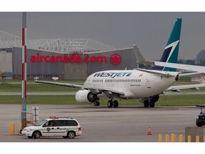A Westjet plane taxis to the runway at Montreal's Pierre Elliot Trudeau airport in Montreal Wednesday June 29, 2011.