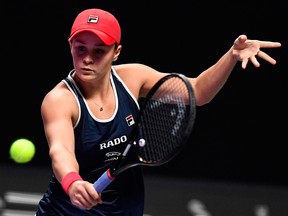 Ashleigh Barty of Australia hits a return against Belinda Bencic of Switzerland during their women's singles first round match in the WTA Finals tennis tournament in Shenzhen on Oct. 27, 2019.